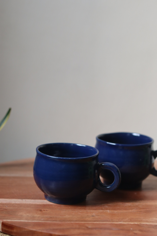 Bright blue coffee mug on wooden surface
