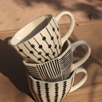 black patterned mugs made by ceramic 