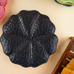black cabbage snack plate with cabbage leaf design