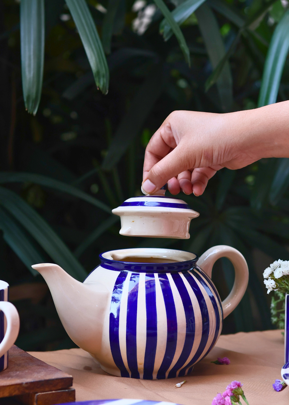 Tea pot with blue stripes on it