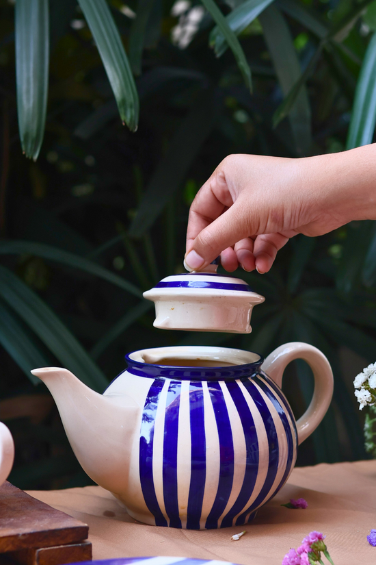 Tea pot with blue stripes on it