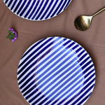 Two ceramic plates with spoon