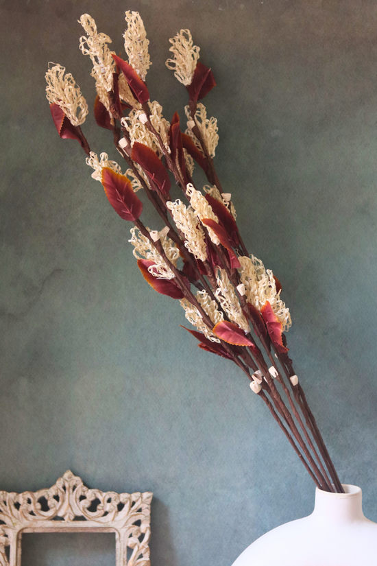 Dried flower bunch in white flower vase