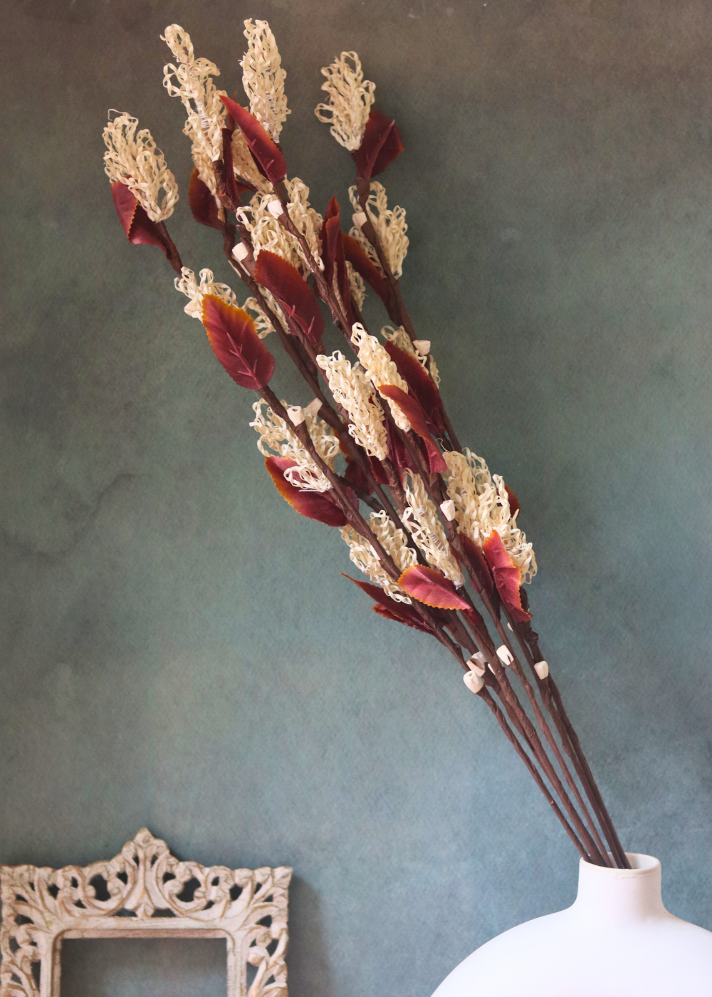 Dried flower bunch in white flower vase