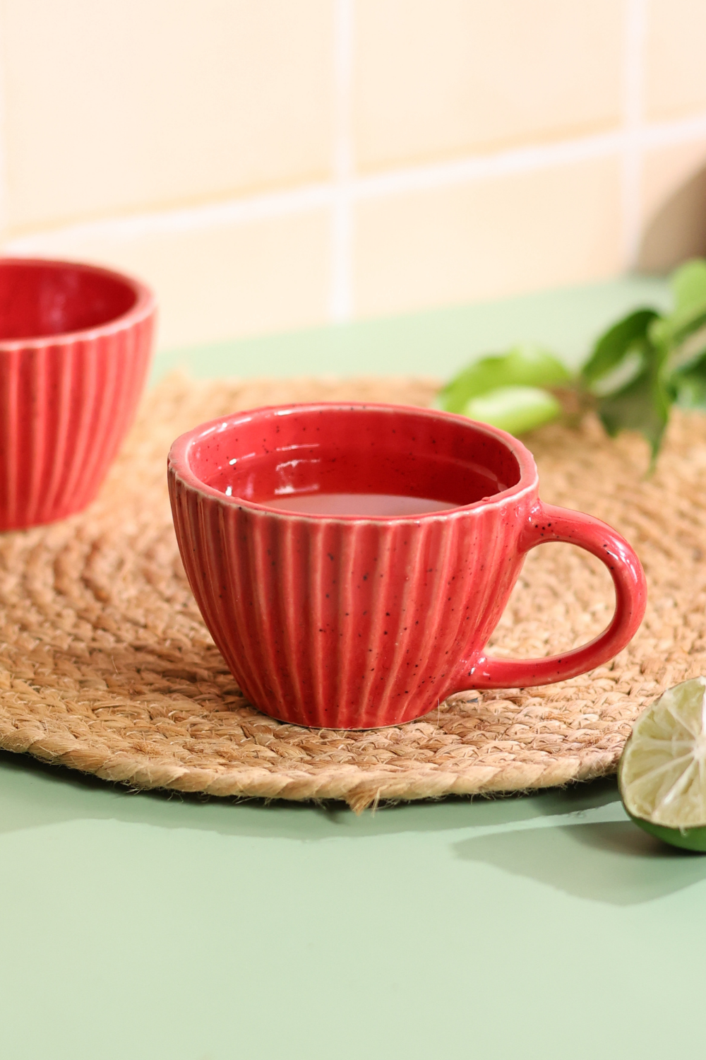 Red striped coffee mug with tea inside 