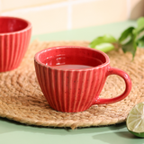 Red striped coffee mug with tea inside 