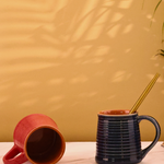 red & blue coffee mug made by ceramic 