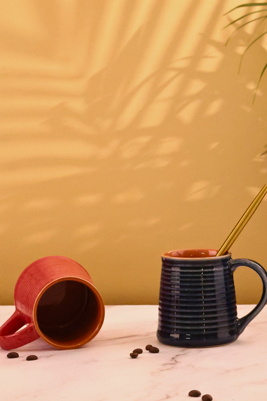 red & blue coffee mug made by ceramic 