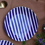 White plate with blue stripes on it