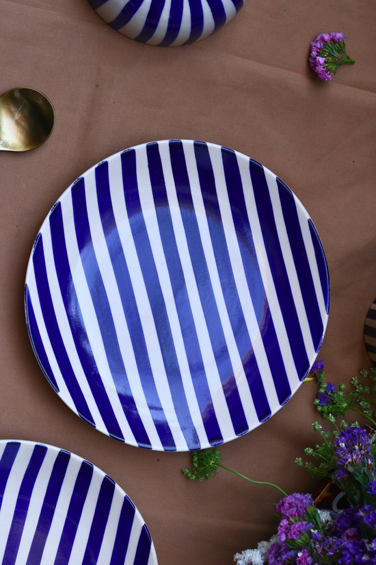 White plate with blue stripes on it