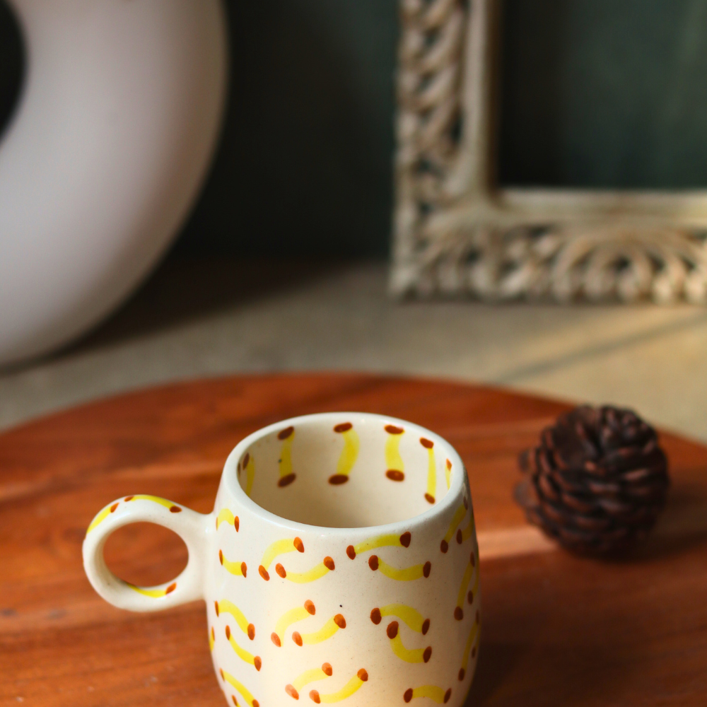 Handmade banana designed coffee mug on a wooden surface