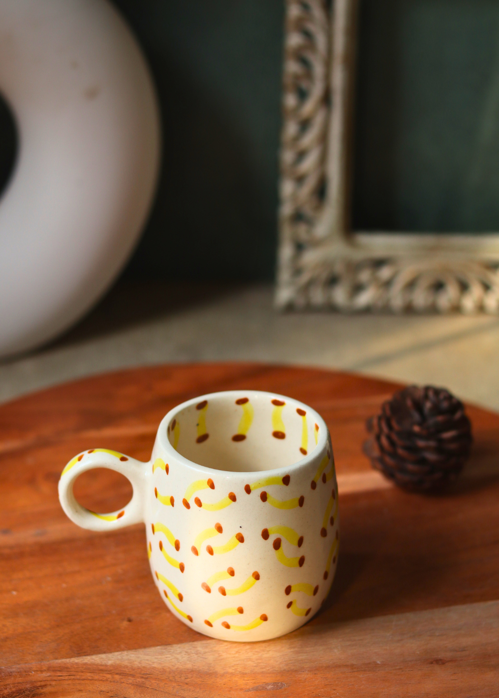 Handmade banana designed coffee mug on a wooden surface