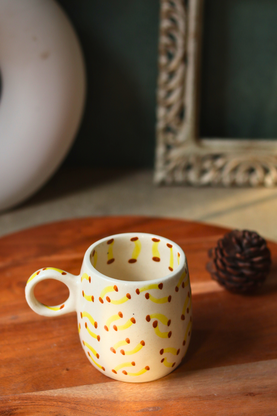 Handmade banana designed coffee mug on a wooden surface