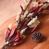 Dried flower bunch laying on a wooden surface