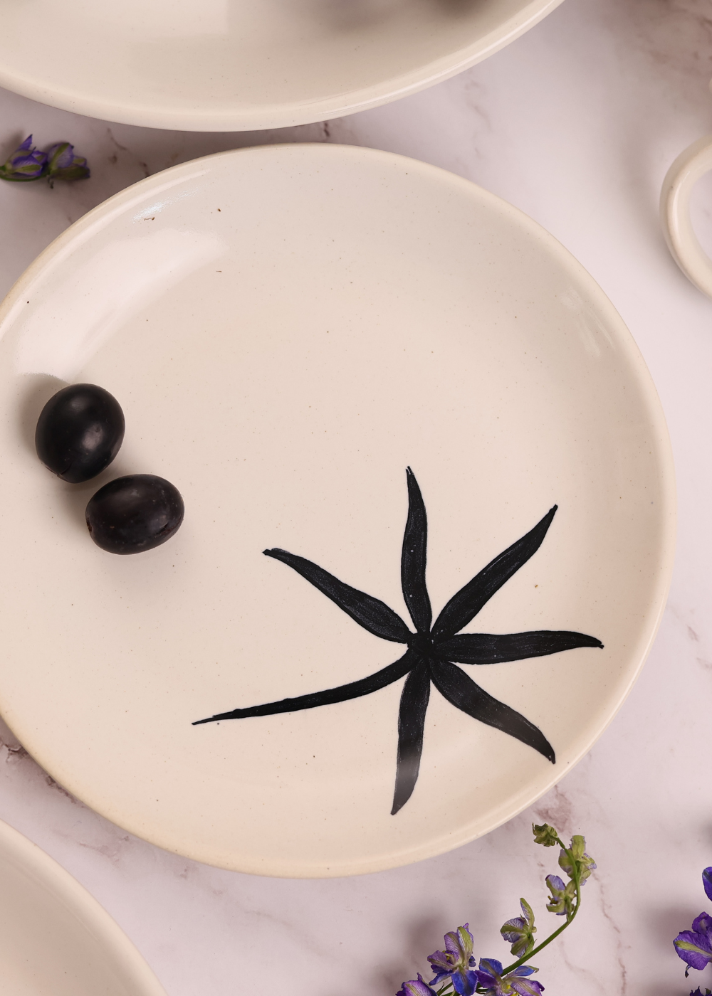 White plate with black leaf print on it