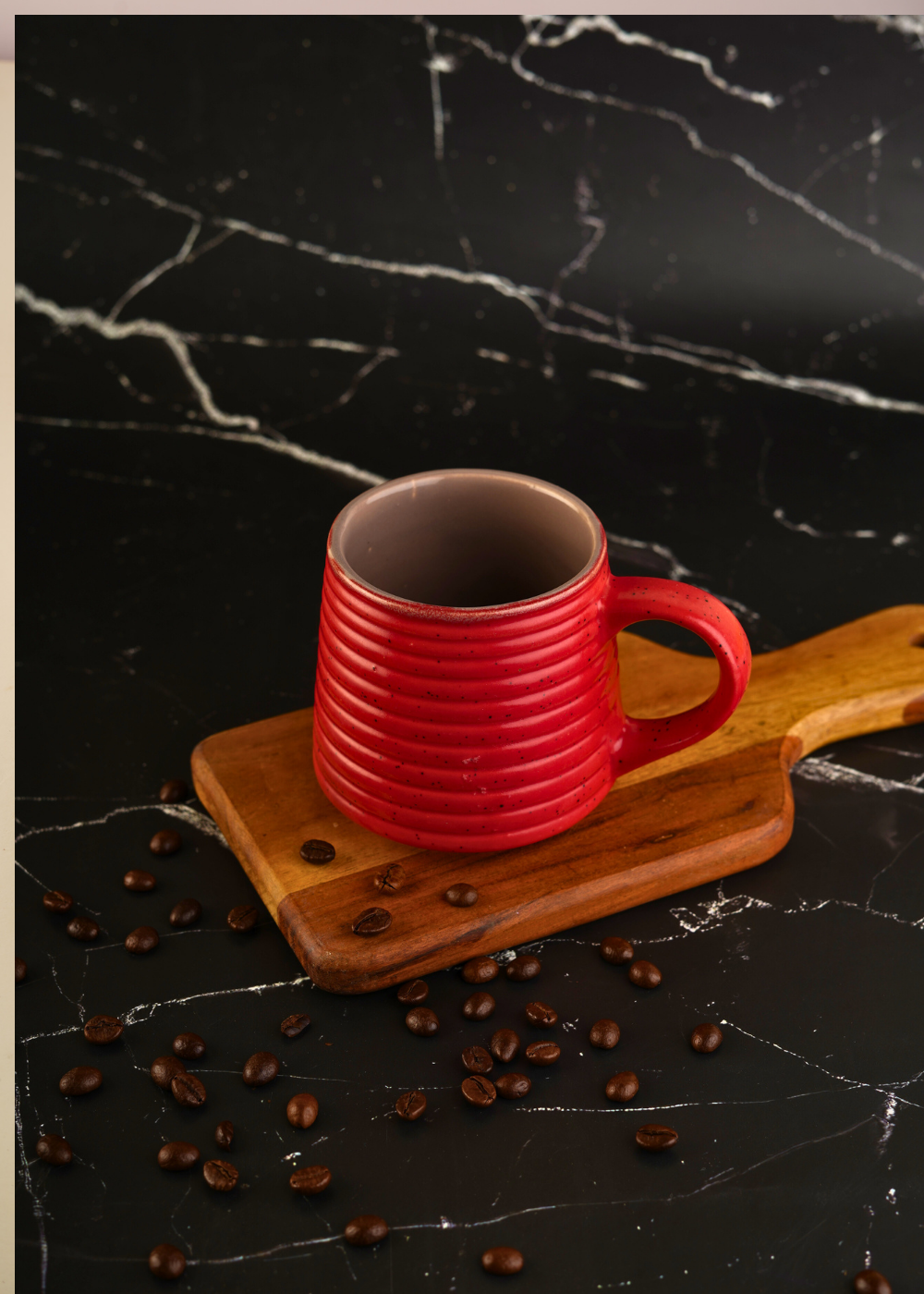 Hot red coffee mug on wooden surface
