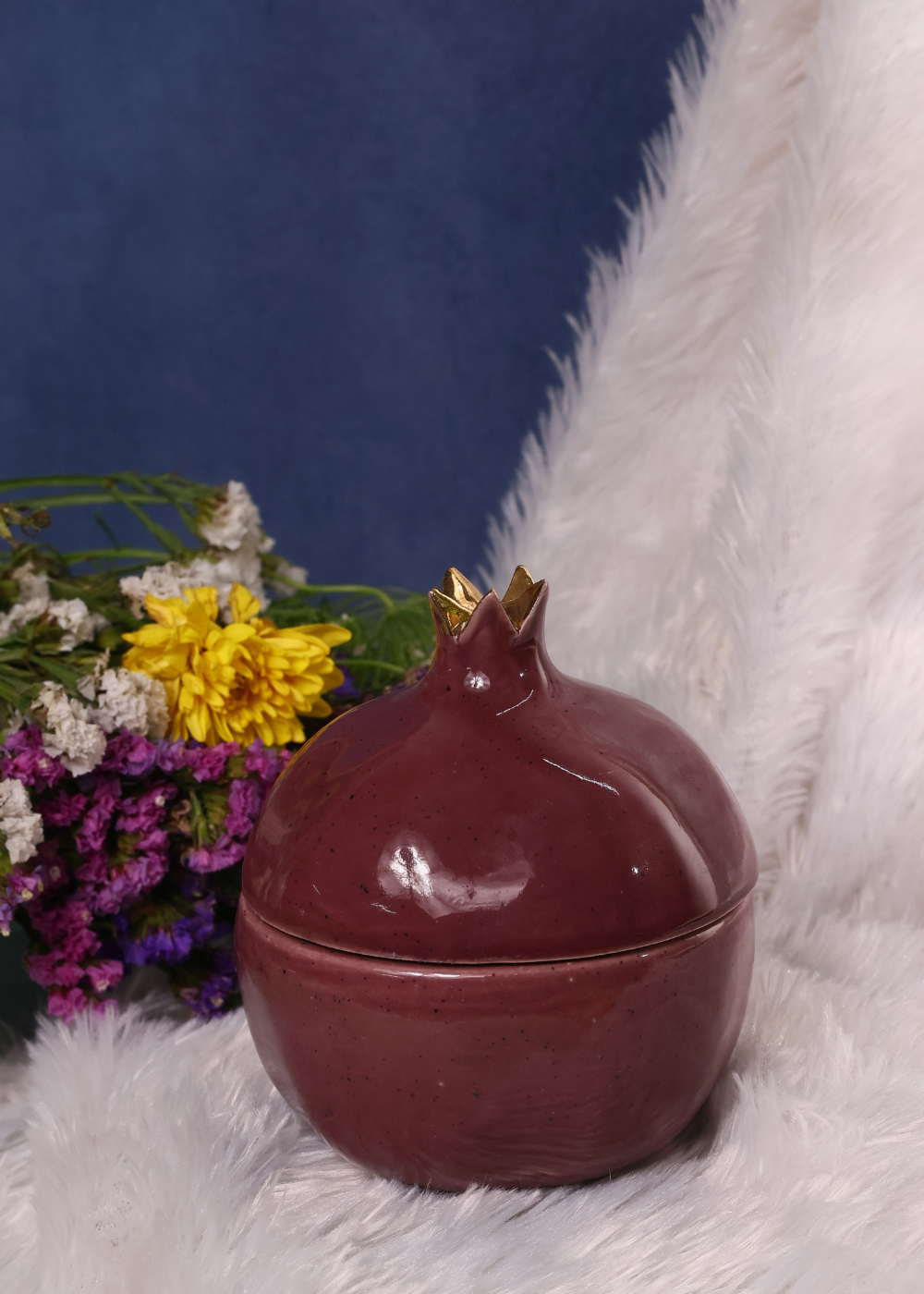 Anar jar on a white cloth with flowers
