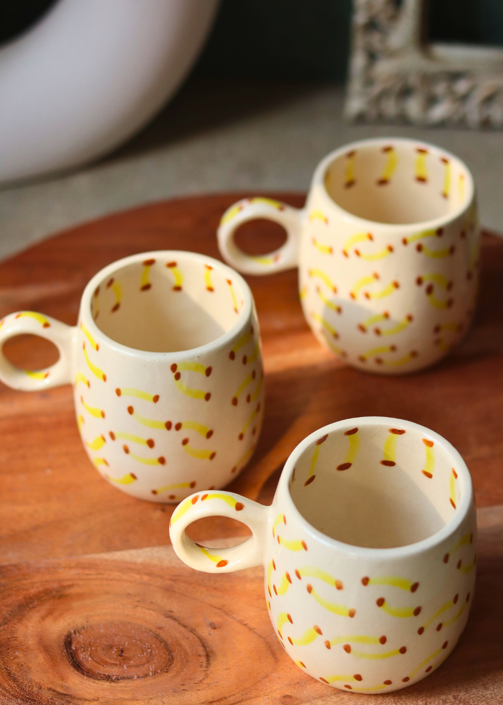 Three ceramic mugs on a wooden surface