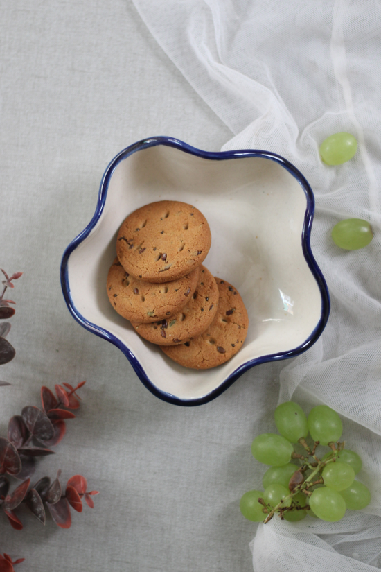 Handmade ceramic curvy bowl with cookies