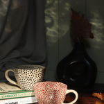 red & black polka mugs made by ceramic 