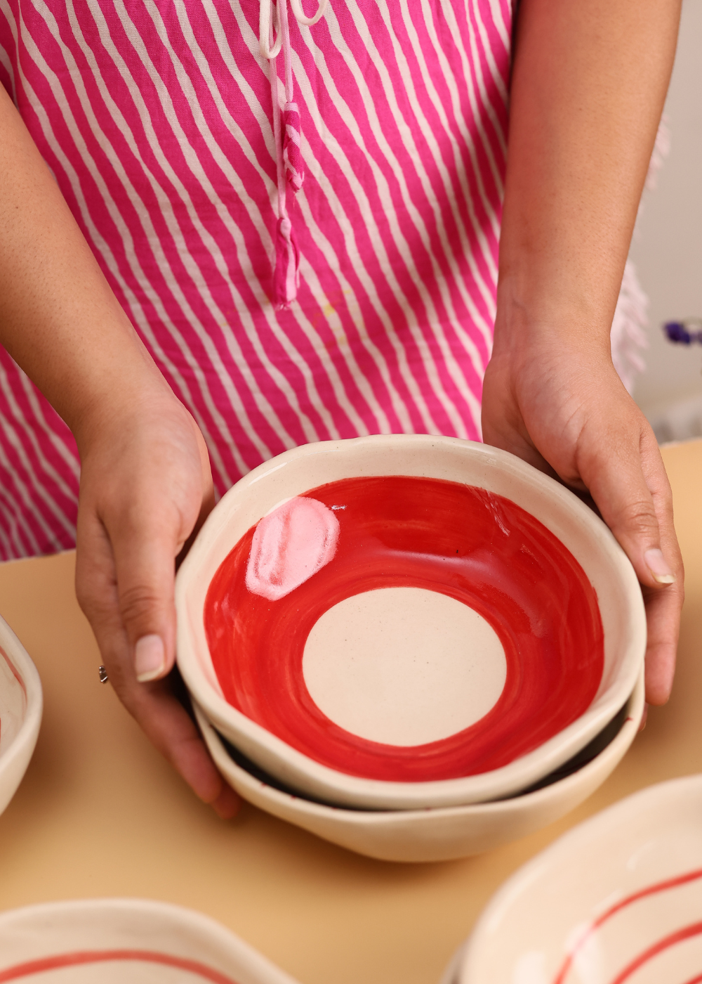 Red and white bowls in hand 