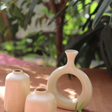 cream bud vase made by ceramic 