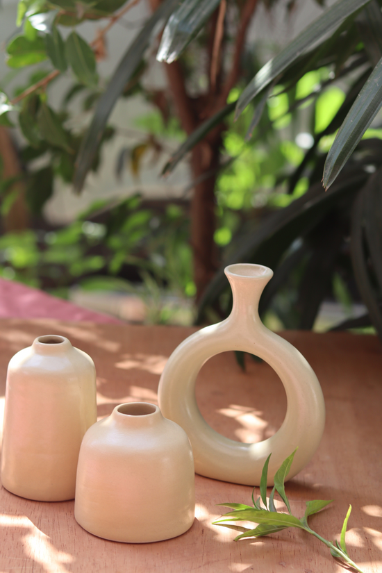cream bud vase made by ceramic 