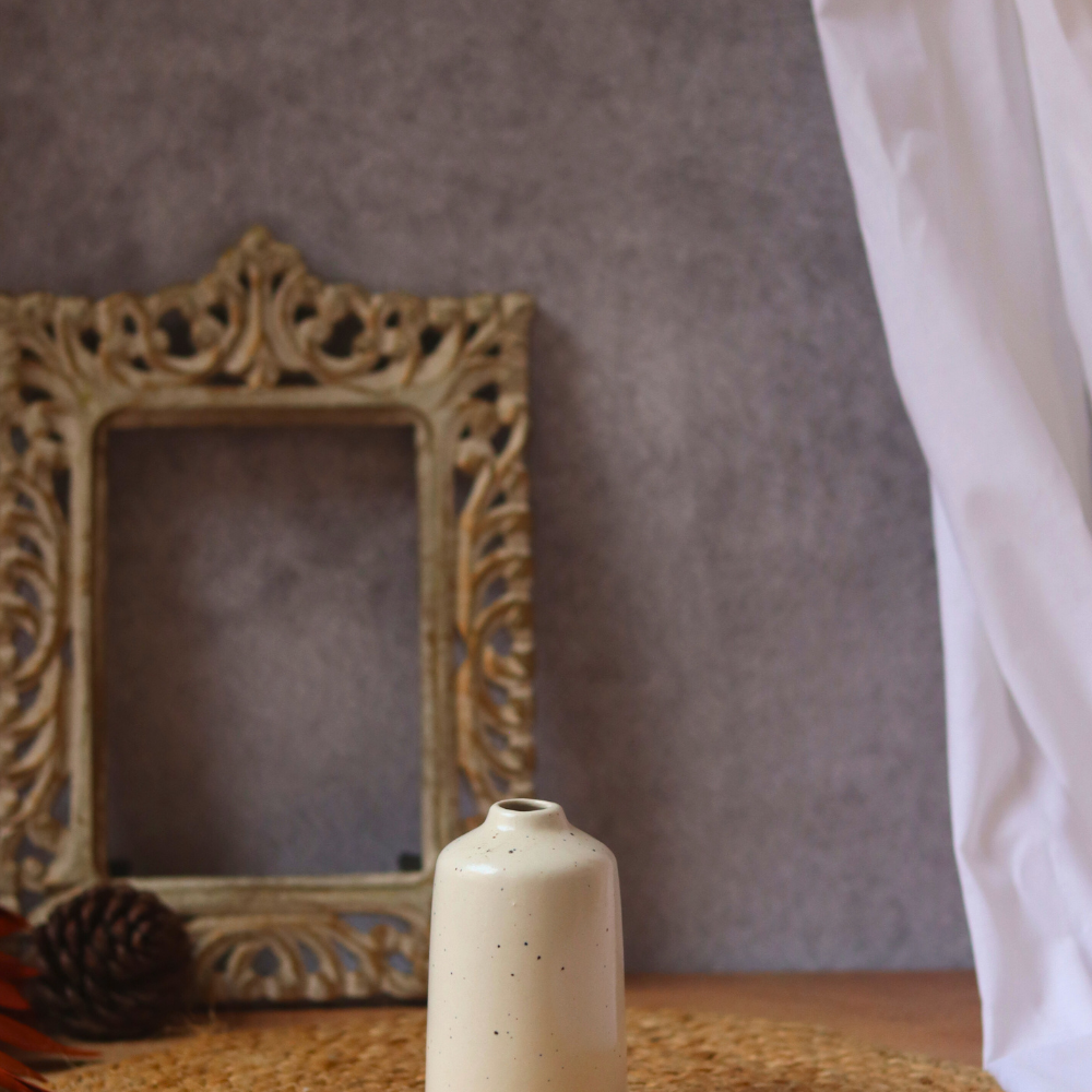Cream bud vase tall on mat