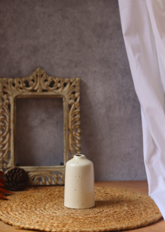 Cream bud vase tall on mat