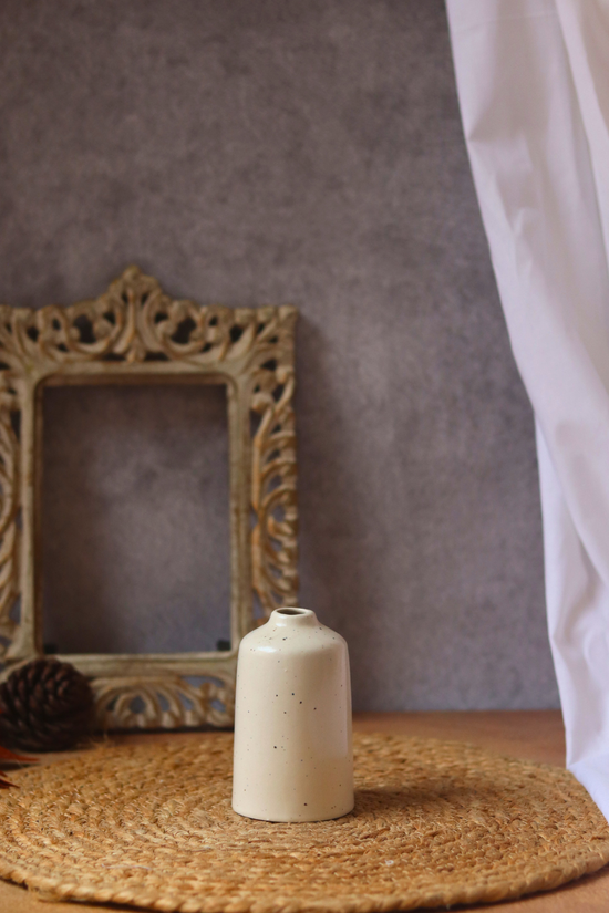 Cream bud vase tall on mat