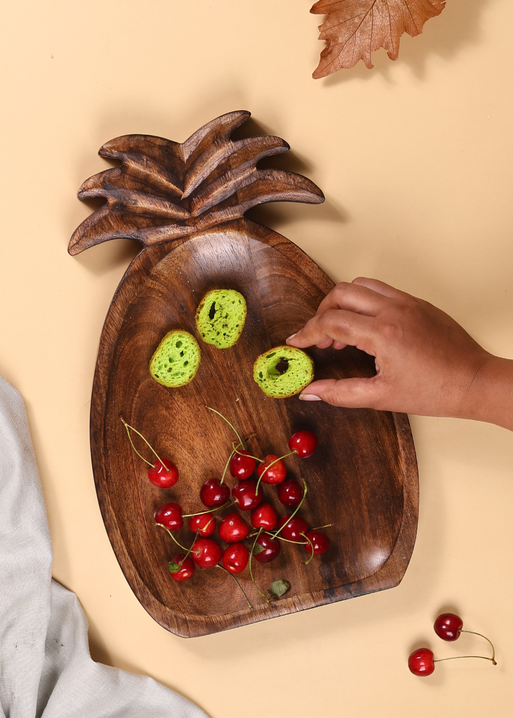 Pineapple shaped wooden platter with cherries 