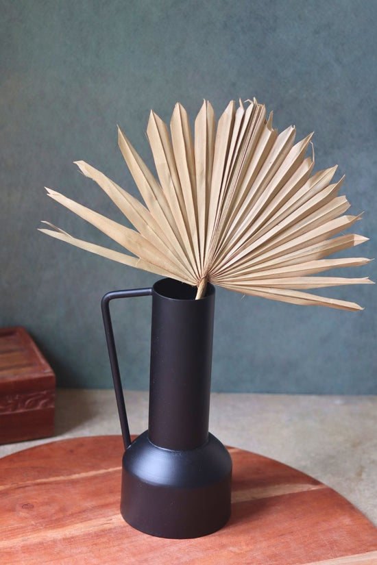 black tall vase made by metal