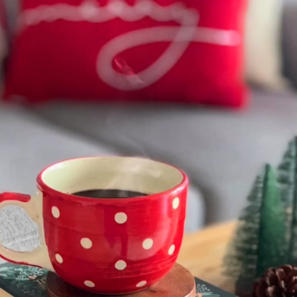 Red and white mug with black tea