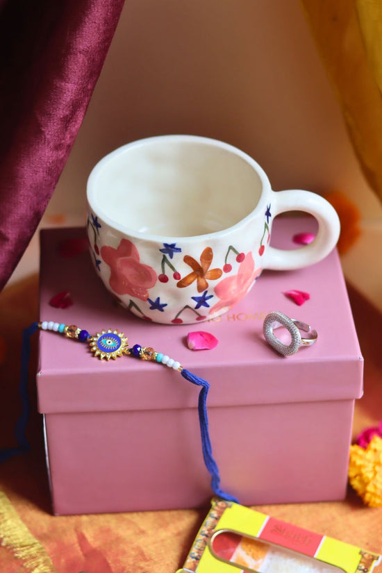  Rakhi Bloom Mug gift box with Rakhi & Earrings is crafted only for this rakhsha bandhan