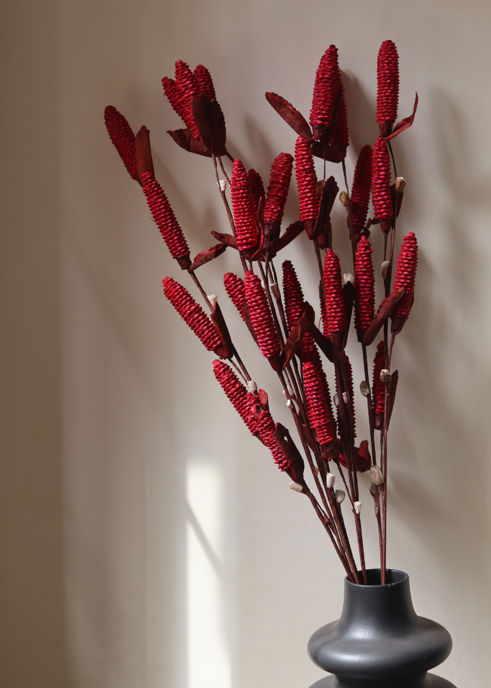 Dried red pine chain bouquet in vase