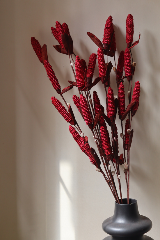Dried red pine chain bouquet in vase