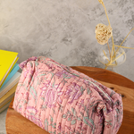 Block printed pink floral bag on a wooden surface