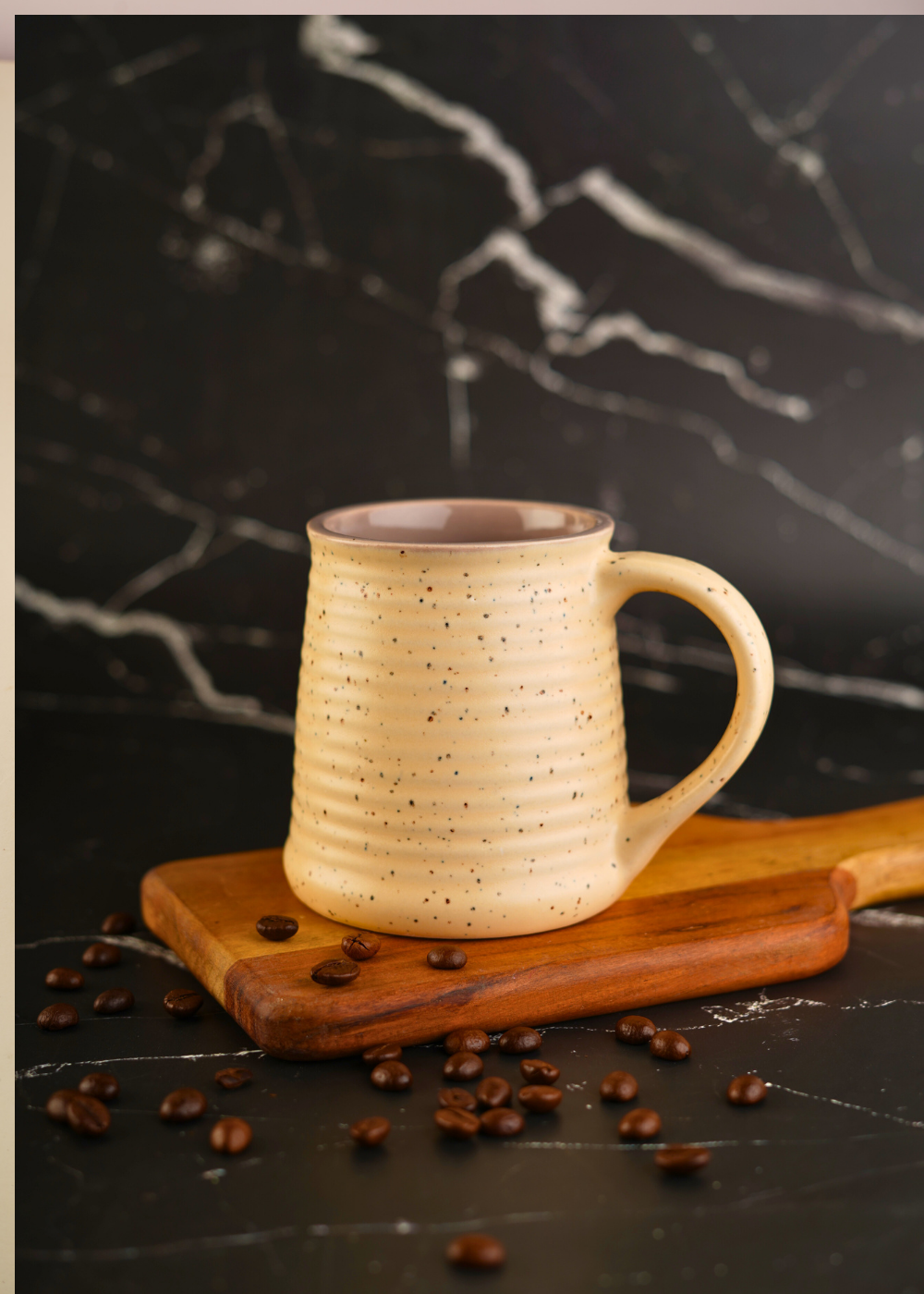 Handmade ceramic coffee mug with beans