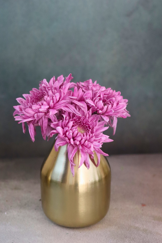 Brass glowing amber vase with pink flowers 