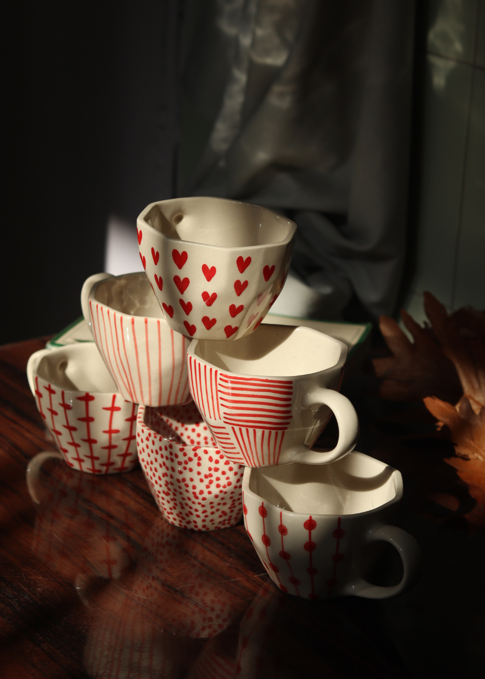 red & white mugs made by ceramic 