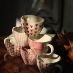red & white mugs made by ceramic 