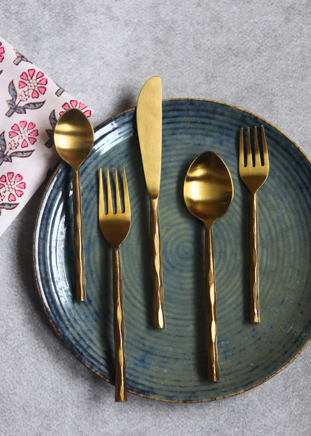 Handmade gold cutlery set on plate 