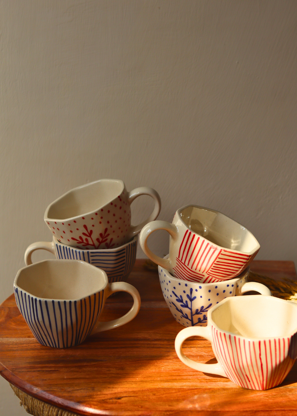 red & blue handmade mugs made by ceramic 