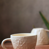 cream textured mug with unique design