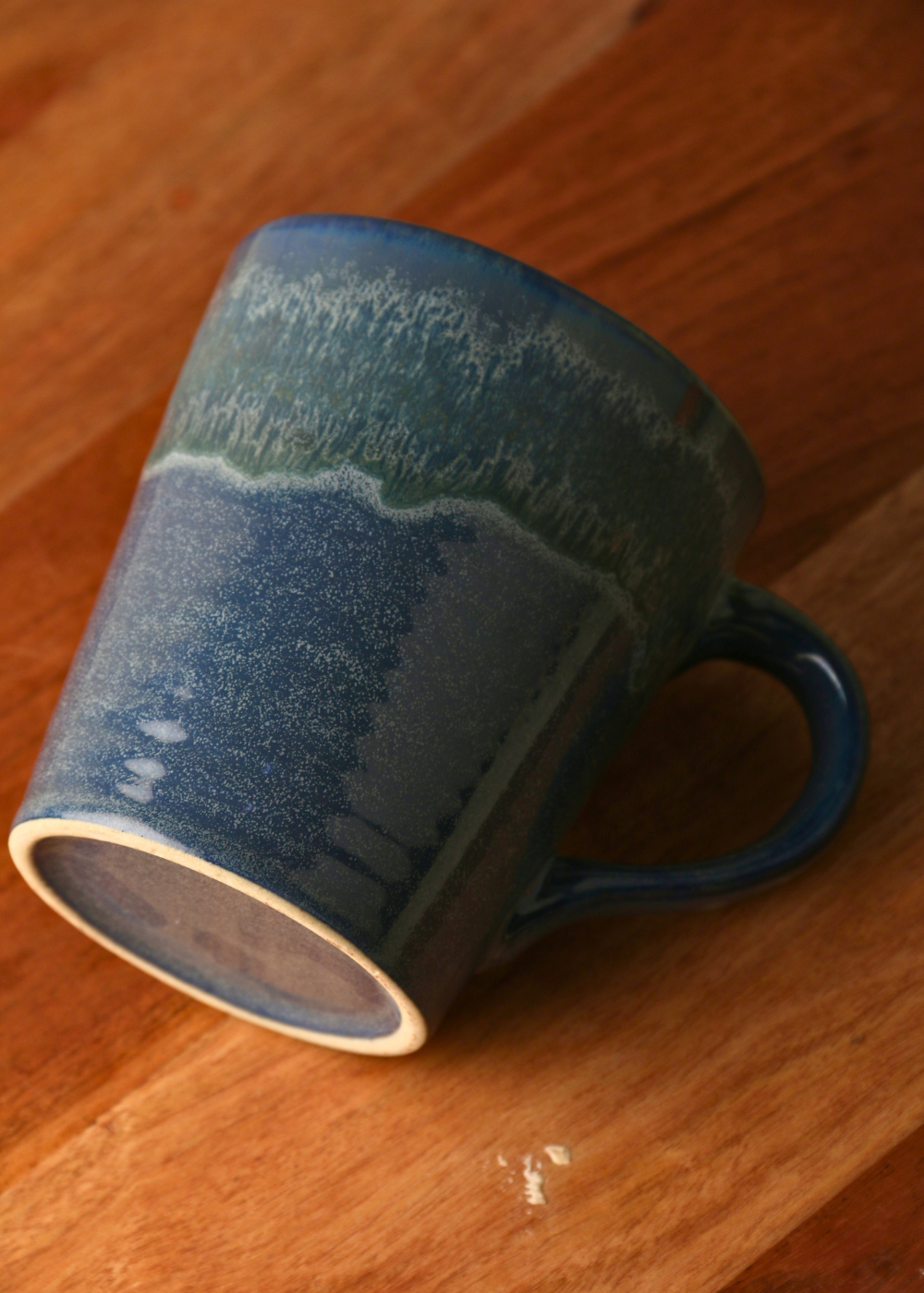 Ceramic coffee mug on wooden surface