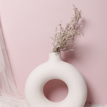 White donut flower vase with flowers