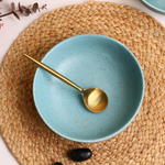 ceramic curry bowl with golden spoon