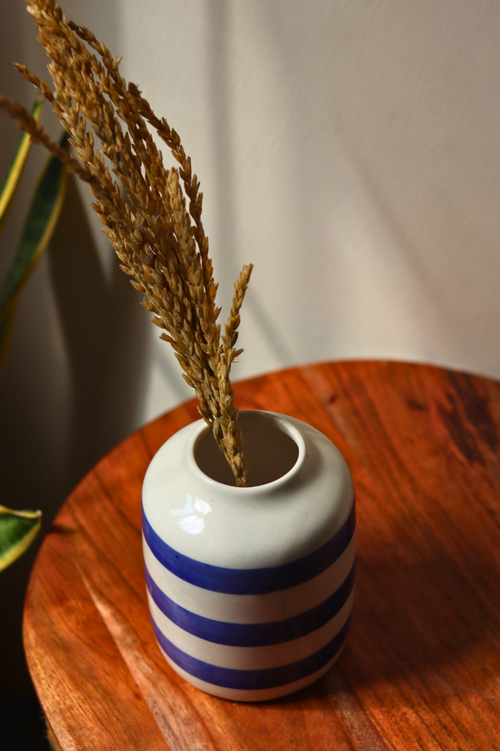Striped blue flower vase with dried bunch