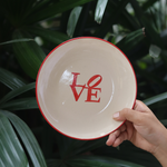 Ceramic love snack plate in hand 