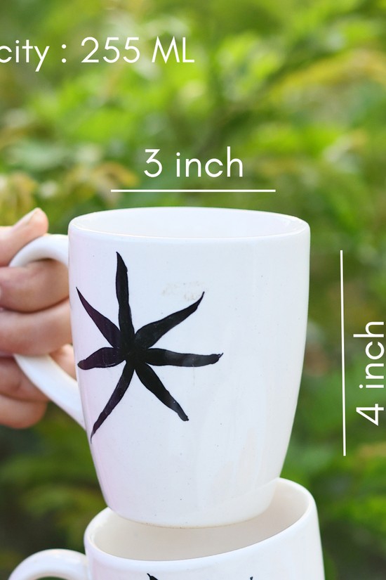 Handmade ceramic coffee mug in hand 